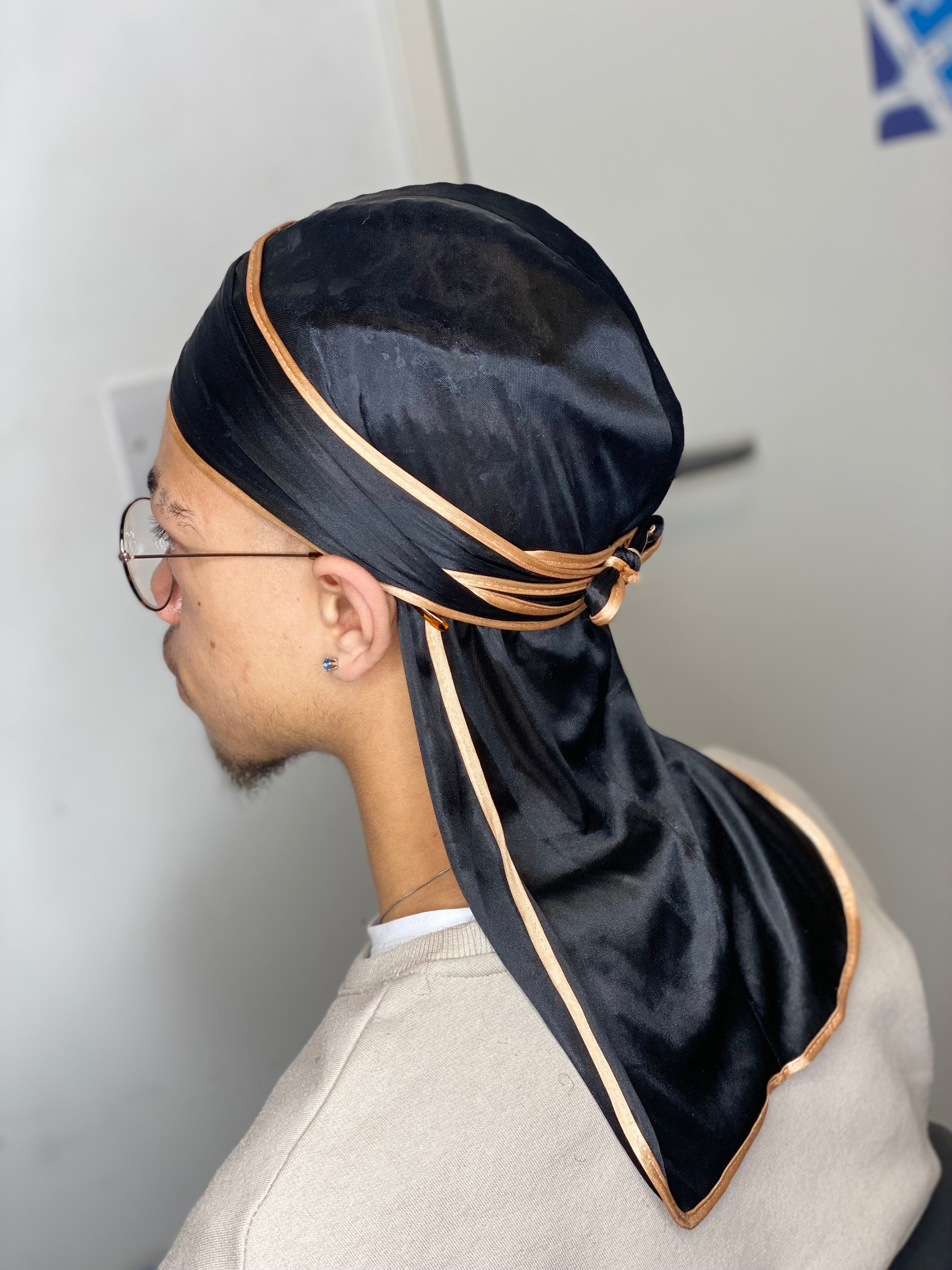 Black silky durag with gold stripes